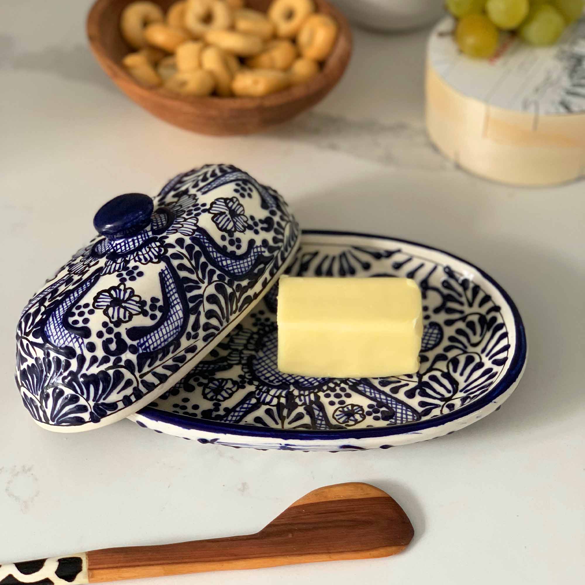Authentic Mexican Pottery butter dish in blue and white flower design with hand-carved wood serving piece from Kenya.